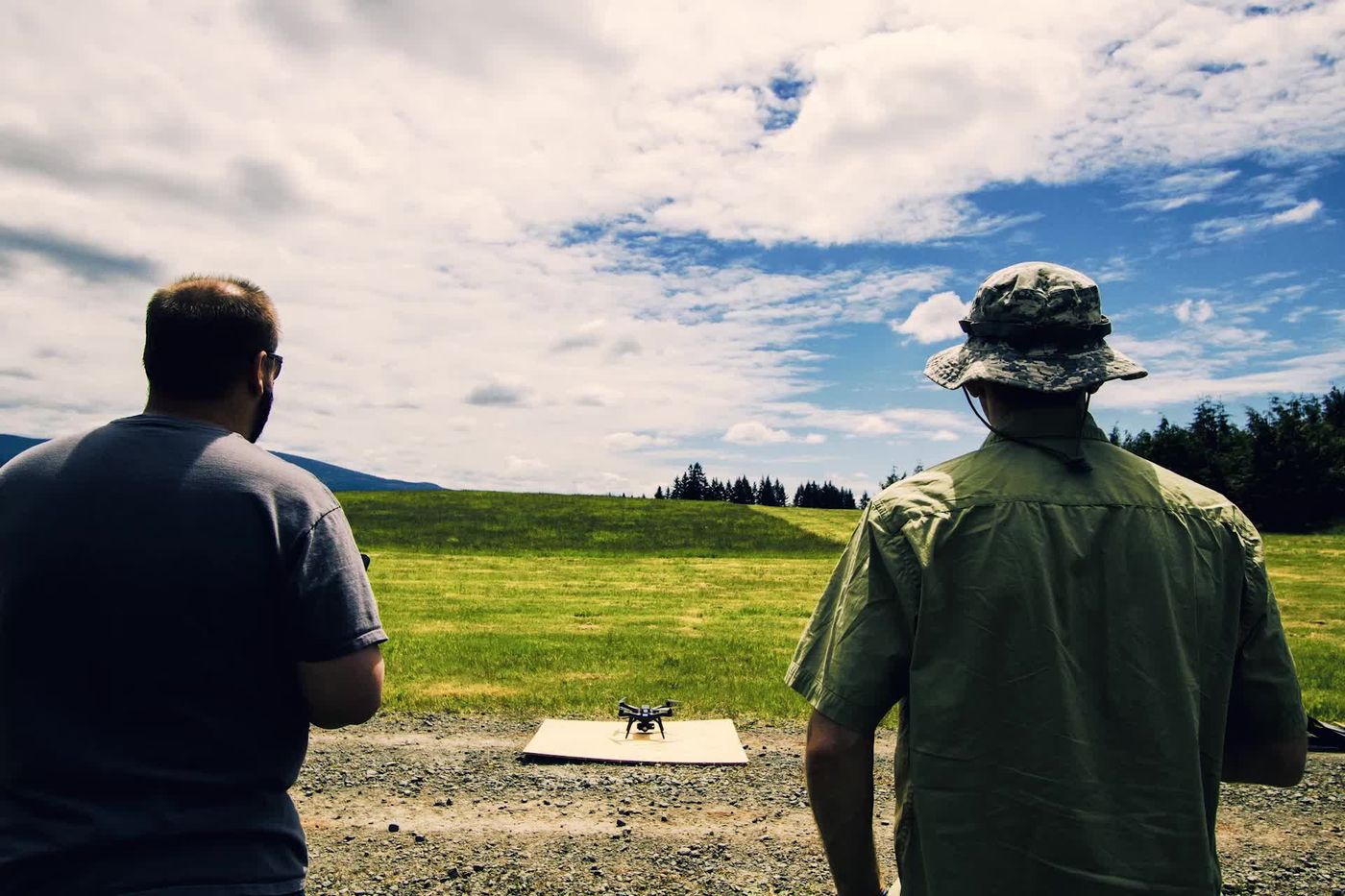 Operators practise flying a small quadcopter.