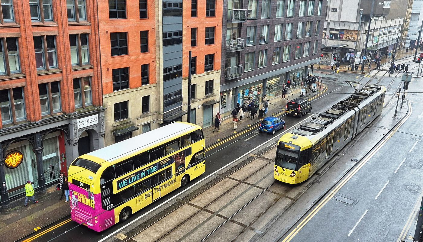 A yellow Bee Network bus in Manchester city centre.