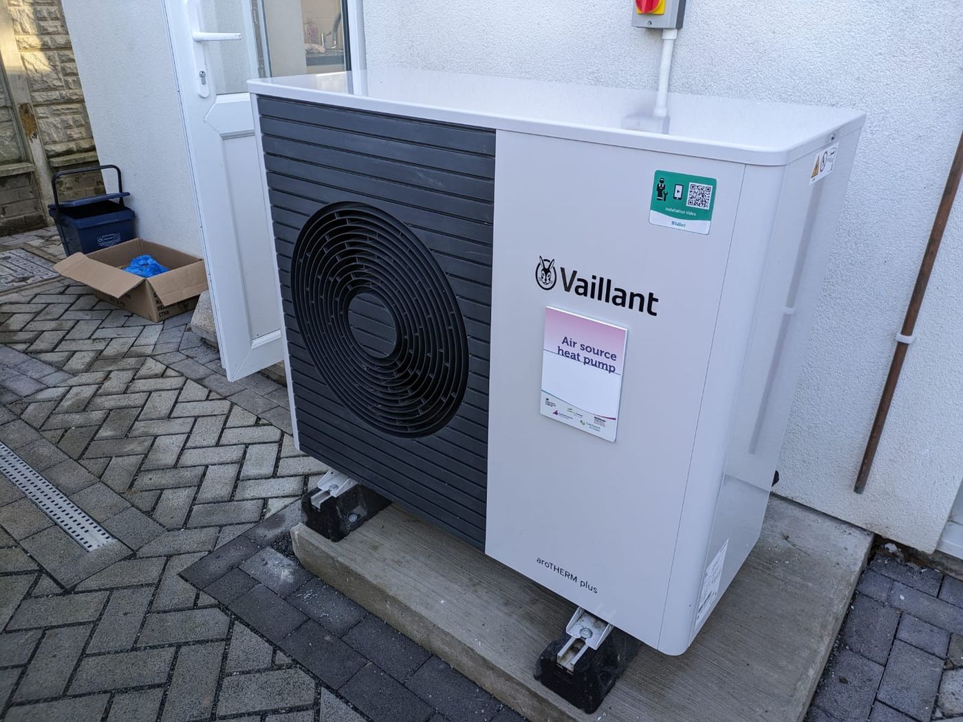 An air source heat pump installed outside a house in Britain.
