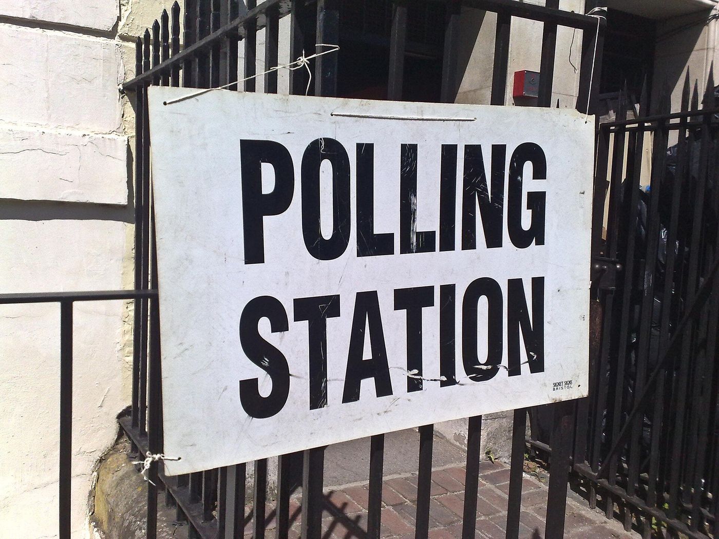 A polling station sign outside a community hall.