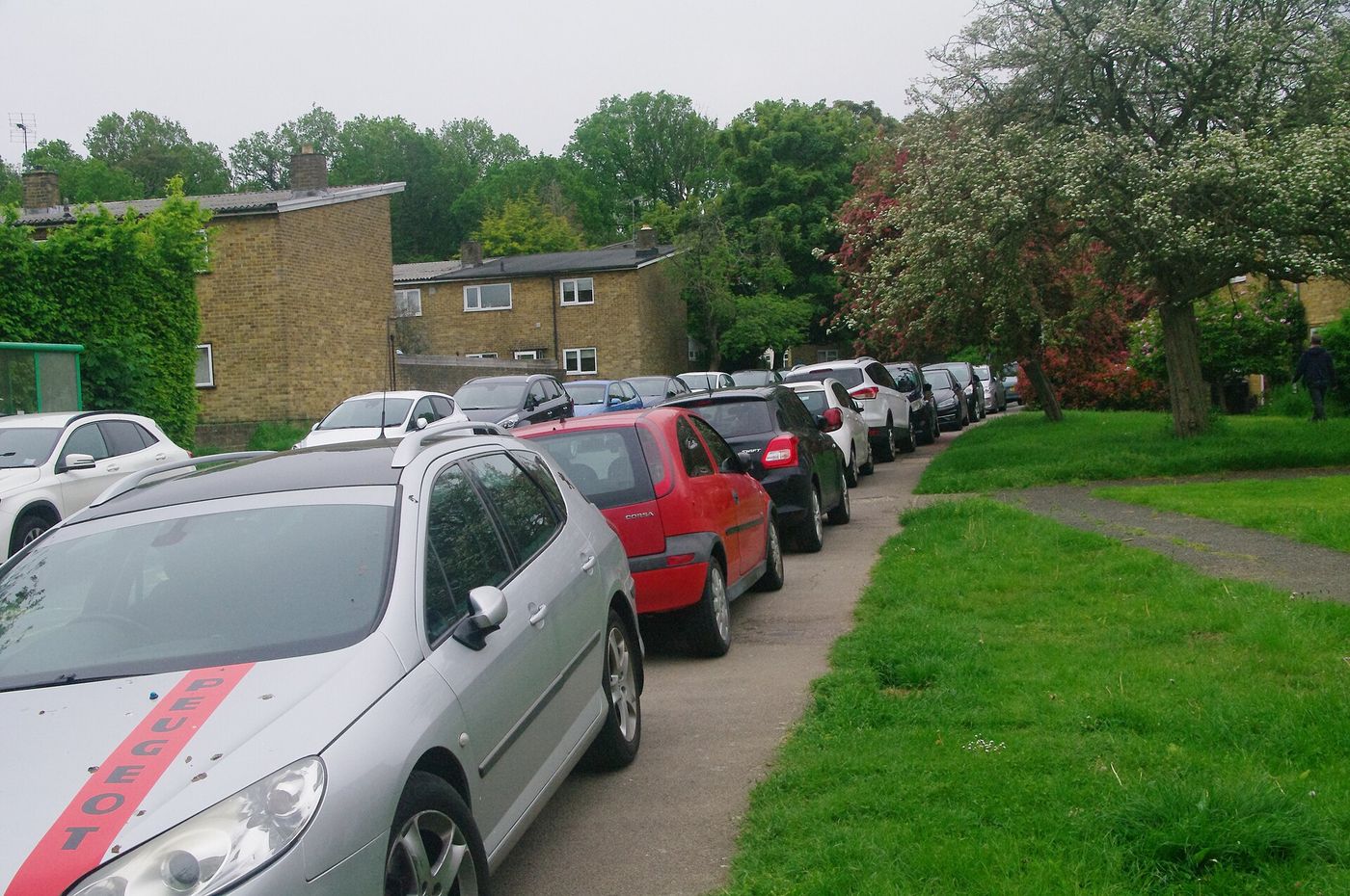 A car parked across a pavement in a residential street. The practice has been banned in London since 1974.