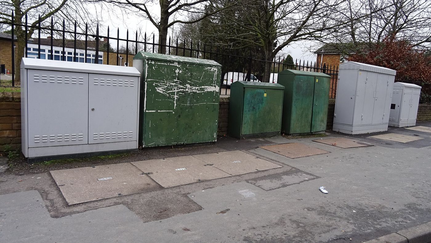 A fibre broadband street cabinet on a residential road.