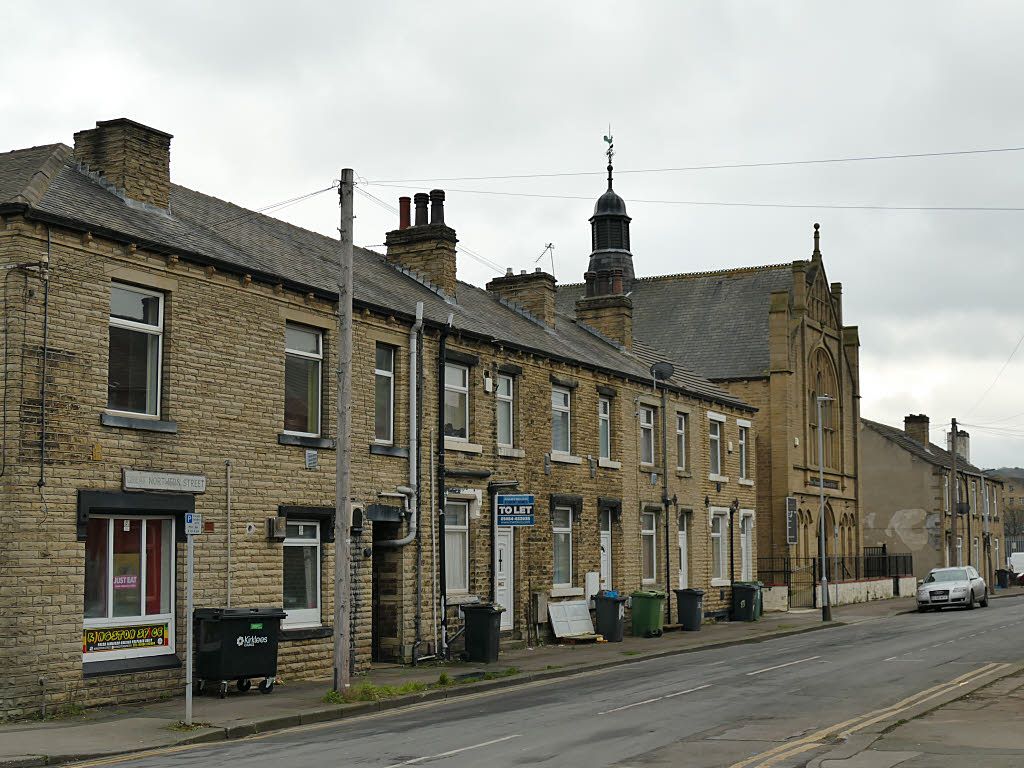 A street of terraced houses in a town in northern England.