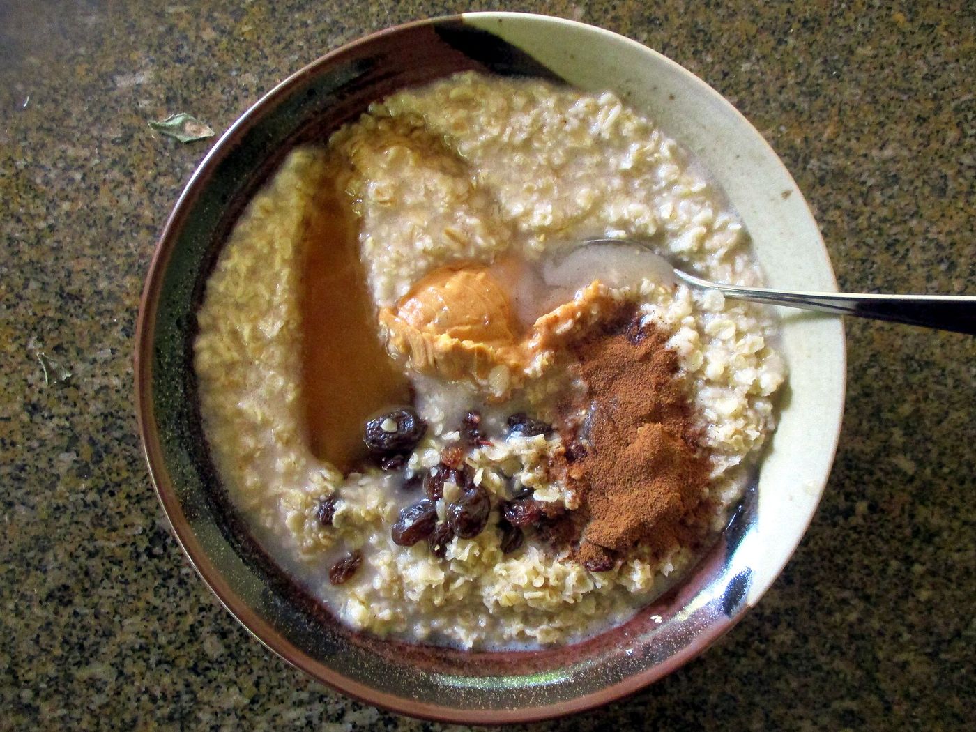 A bowl of porridge oats with seeds and fruit.