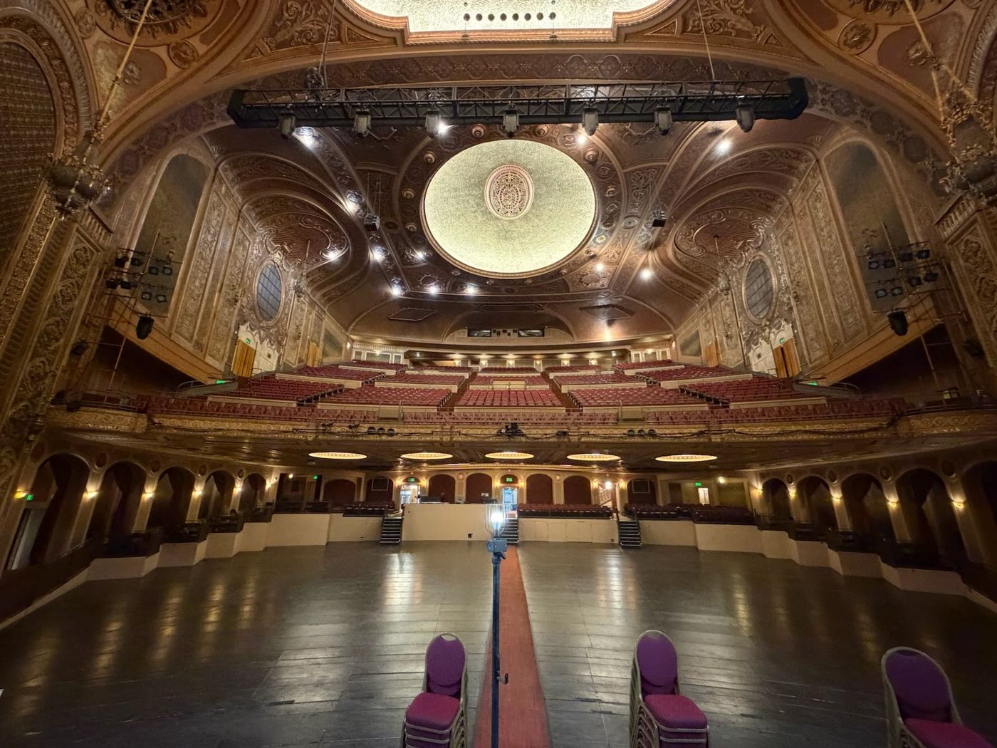 An empty stage lit by a single spotlight.