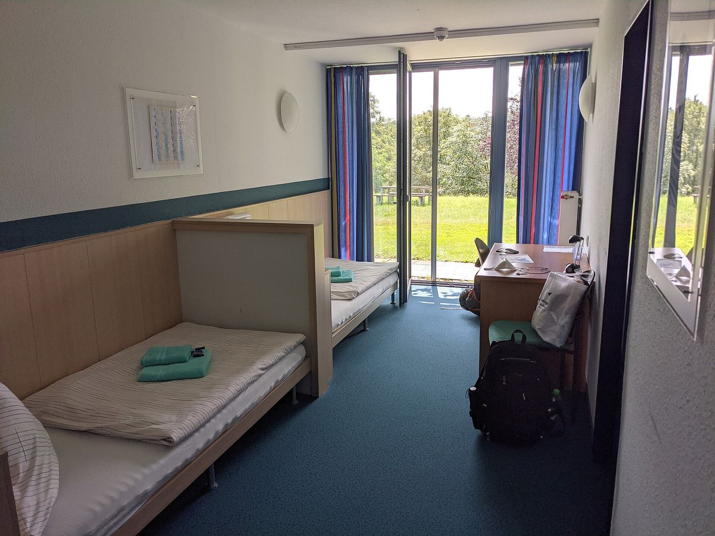 A bedroom with two single beds.
